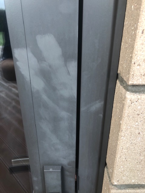 Close up of sun screen lotion damage on window joinery
